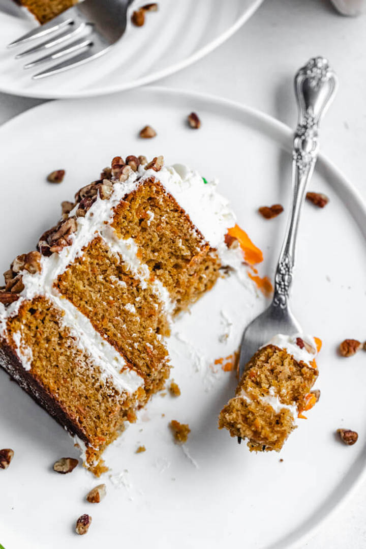 slice of cake with bite taken out of it on a white plate