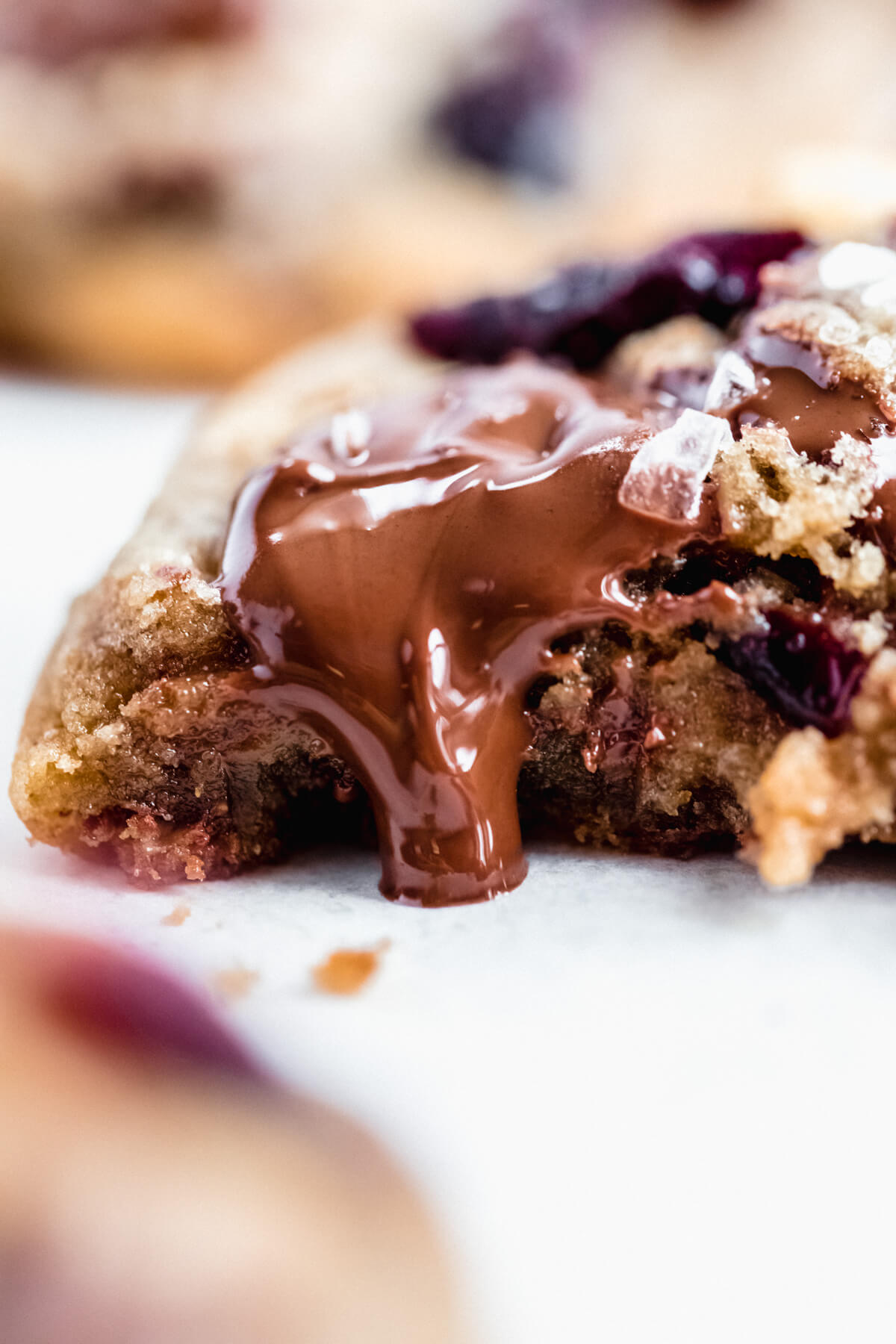 close up of halved cookie with melted dark chocolate