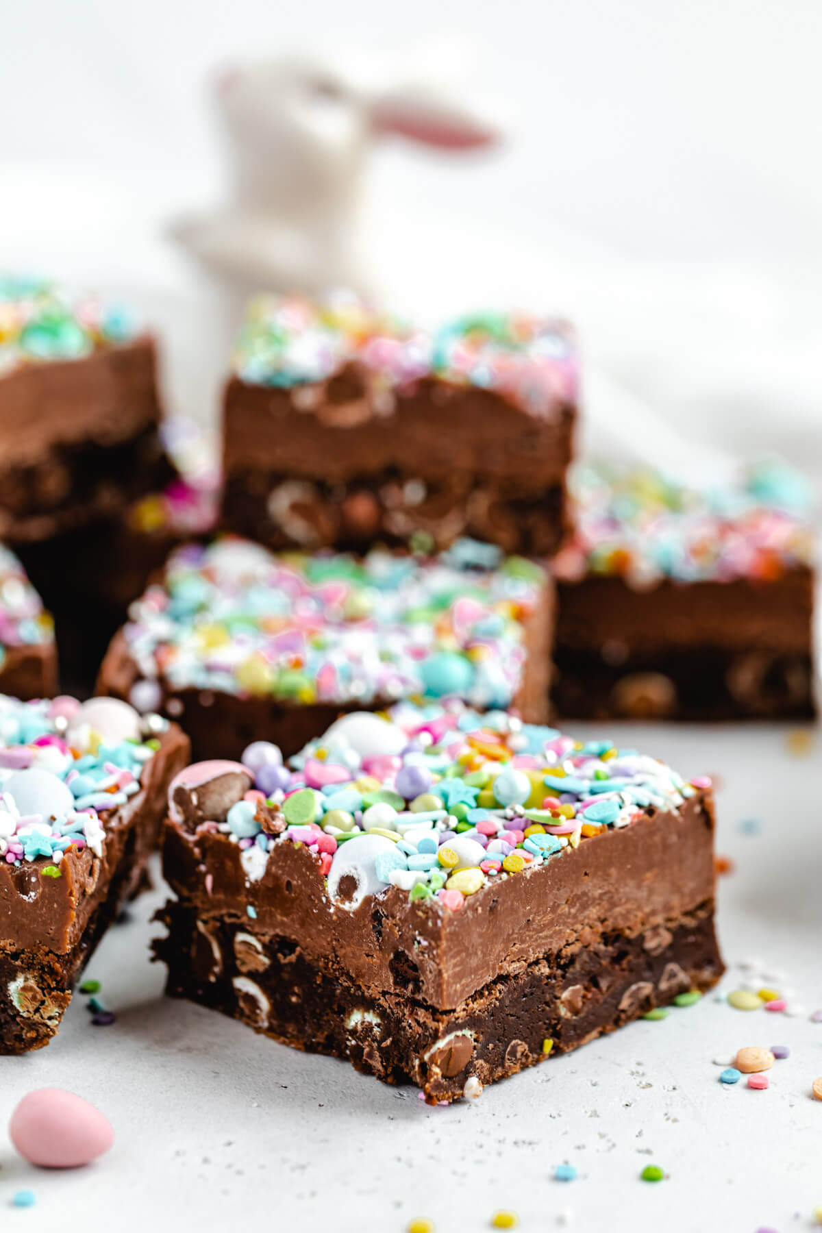 close up of brownie topped with fudge and sprinkles