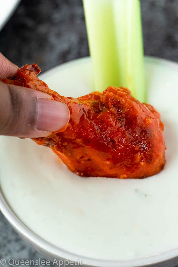 Crispy Baked Buffalo Chicken Wings dipped in blue cheese dressing