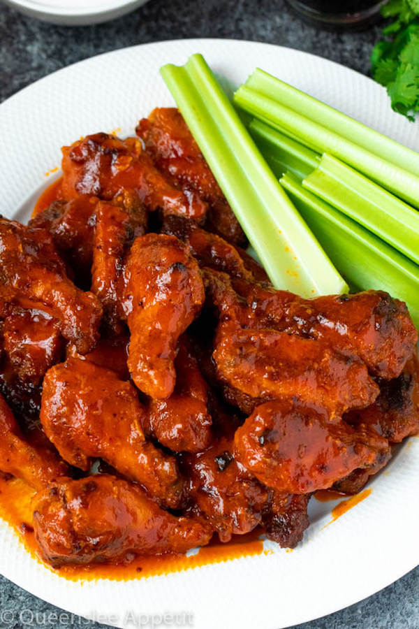 Crispy Baked Buffalo Chicken Wings with celery sticks on the side