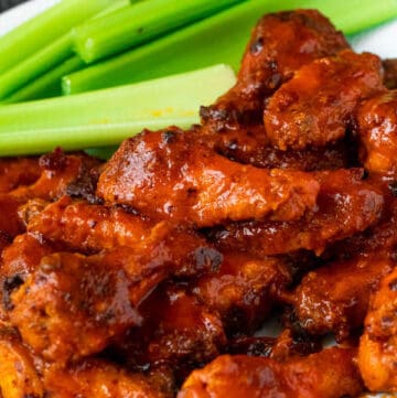 Crispy Baked Buffalo Chicken Wings with celery sticks on the side