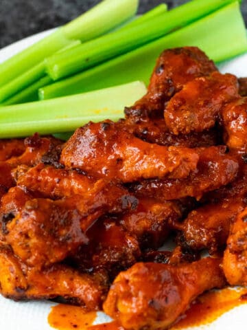 Crispy Baked Buffalo Chicken Wings with celery sticks on the side