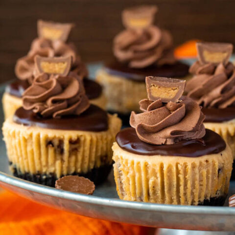 Mini Reese's Peanut Butter Cheesecakes on a cake stand