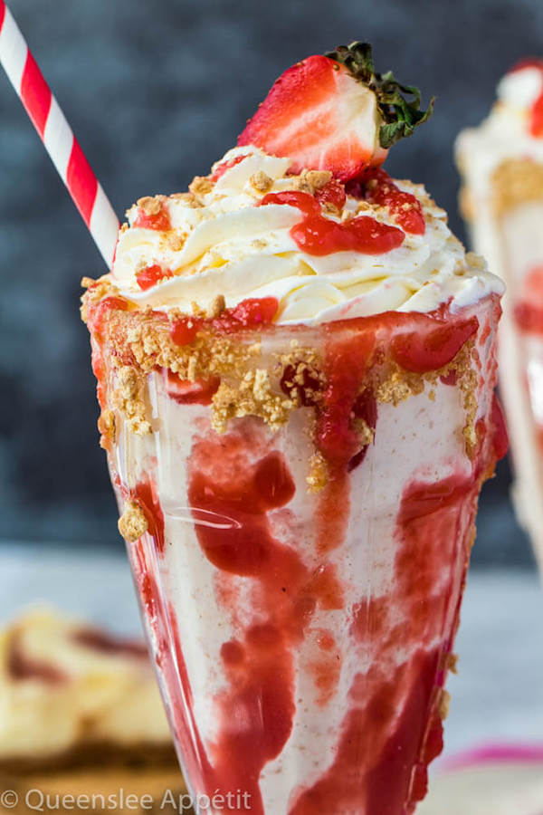 Strawberry Cheesecake Milkshake with Cream Cheese Whipped Cream and strawberries on top