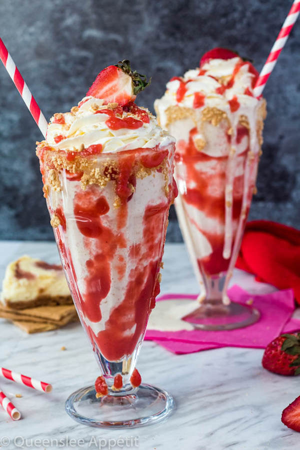 Strawberry Cheesecake Milkshake with Cream Cheese Whipped Cream and strawberries on top