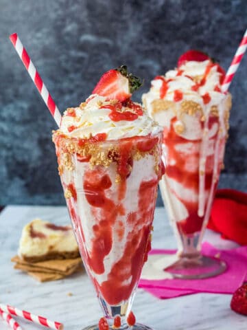 Strawberry Cheesecake Milkshake with Cream Cheese Whipped Cream and strawberries on top