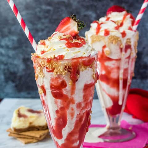 Strawberry Cheesecake Milkshake with Cream Cheese Whipped Cream and strawberries on top