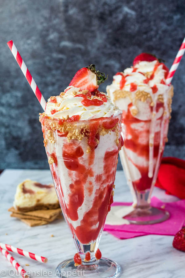 Strawberry Cheesecake Milkshake with Cream Cheese Whipped Cream and strawberries on top