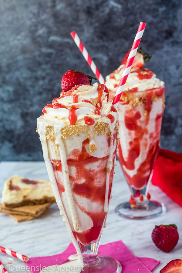 Strawberry Cheesecake Milkshake with Cream Cheese Whipped Cream and strawberries on top