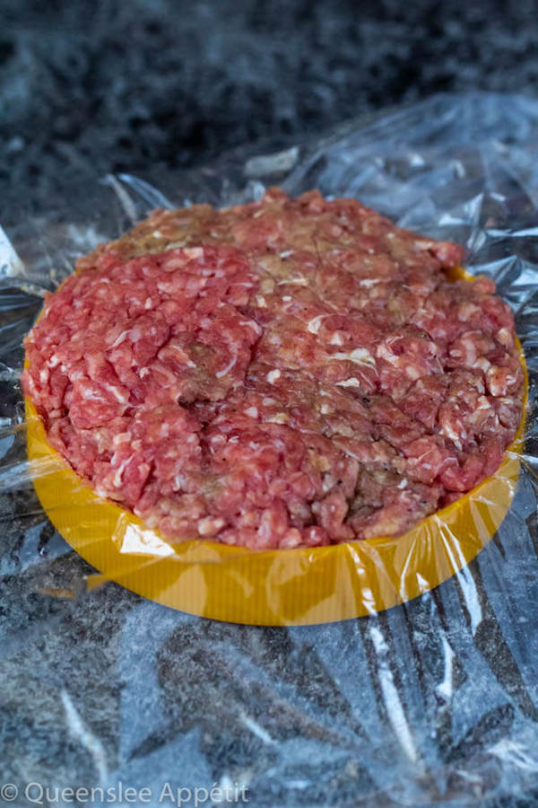 pressing burger patties into a lid