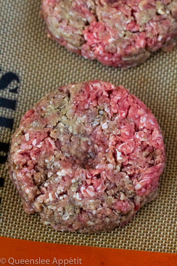 press a dent into the middle of the burger patty to prevent shrinking
