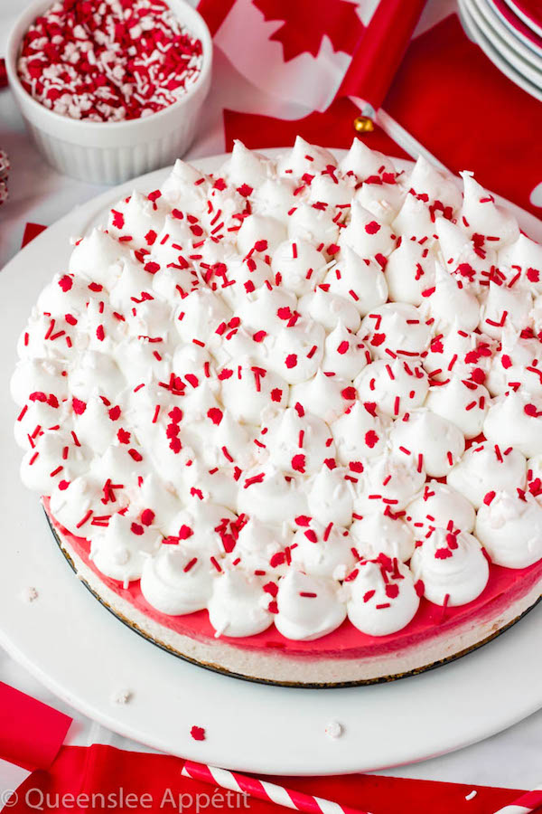 No-bake Canada Day Cheesecake with whipped cream and red and white sprinkles on top
