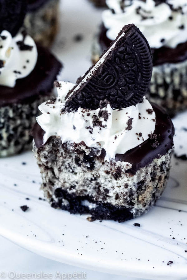 mini cookies and cream cheesecakes on a cake stand