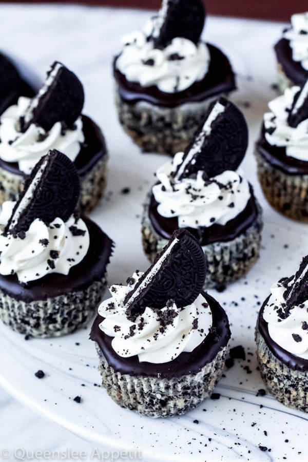 mini cookies and cream cheesecakes on a cake stand