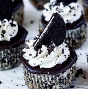 mini cookies and cream cheesecakes on a cake stand