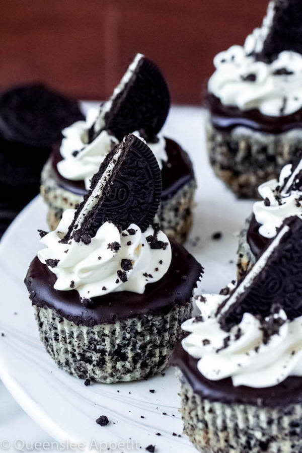 mini cookies and cream cheesecakes on a cake stand