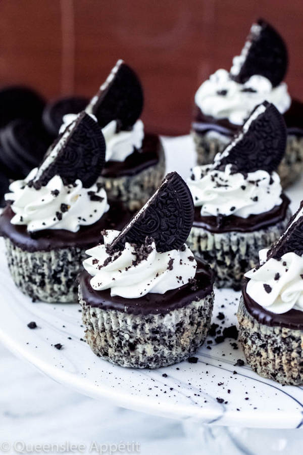 mini cookies and cream cheesecakes on a cake stand