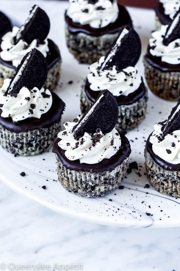 mini cookies and cream cheesecakes on a cake stand