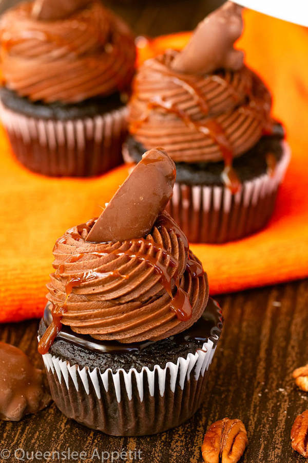 chocolate cupcakes with ganache, chocolate caramel cream cheese frosting, salted caramel and a turtle chocolate on top