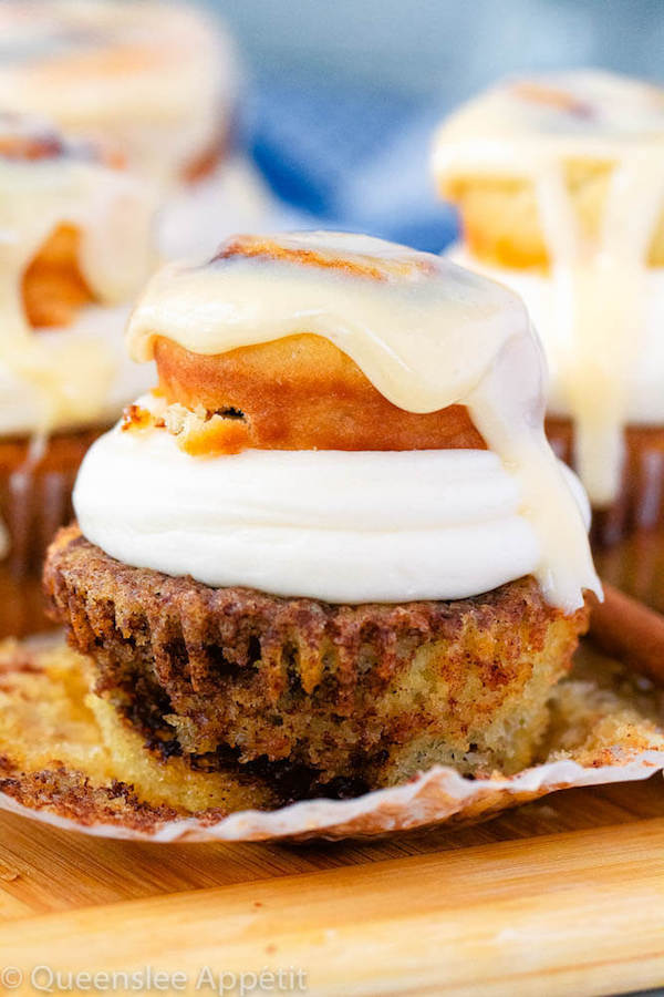 cinnamon roll cupcakes with cream cheese frosting and a glazed mini cinnamon roll on top