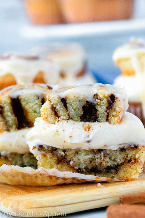 cinnamon roll cupcakes with cream cheese frosting and a glazed mini cinnamon roll on top