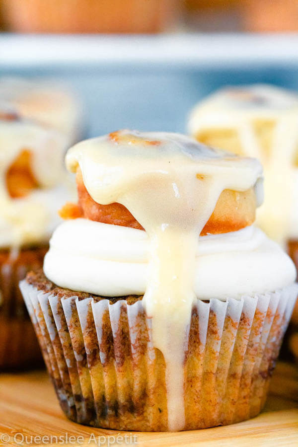 cinnamon roll cupcakes with cream cheese frosting and a glazed mini cinnamon roll on top