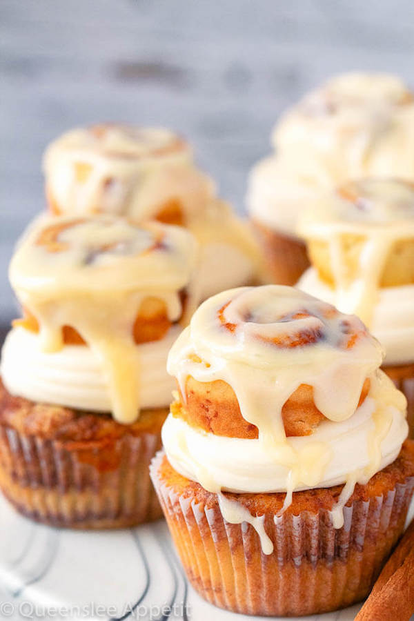 cinnamon roll cupcakes with cream cheese frosting and a glazed mini cinnamon roll on top