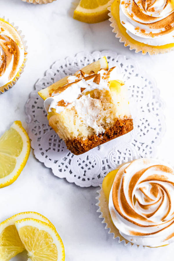 Lemon cupcakes with graham cracker crust, toasted marshmallow filling, lemon curd topping, meringue frosting and a lime and graham cracker crumbs on top