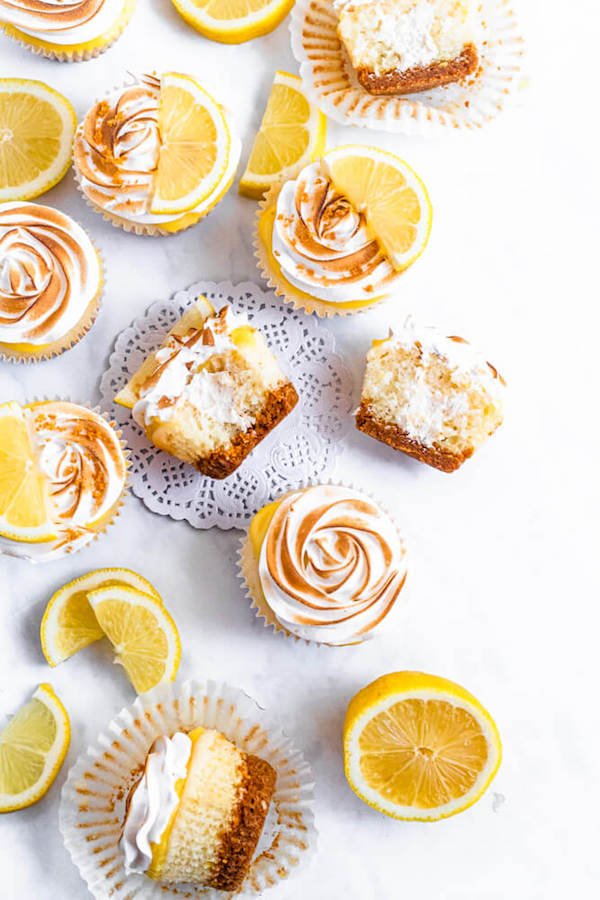 Lemon cupcakes with graham cracker crust, toasted marshmallow filling, lemon curd topping, meringue frosting and a lime and graham cracker crumbs on top