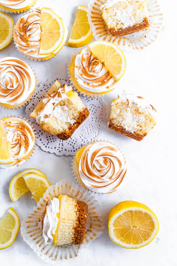 Lemon cupcakes with graham cracker crust, toasted marshmallow filling, lemon curd topping, meringue frosting and a lime and graham cracker crumbs on top