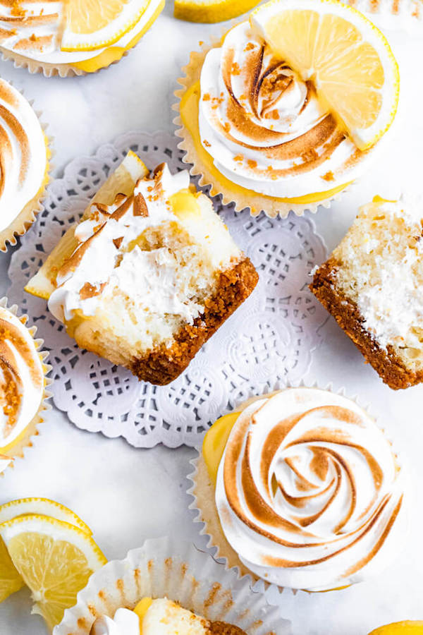 Lemon cupcakes with graham cracker crust, toasted marshmallow filling, lemon curd topping, meringue frosting and a lime and graham cracker crumbs on top