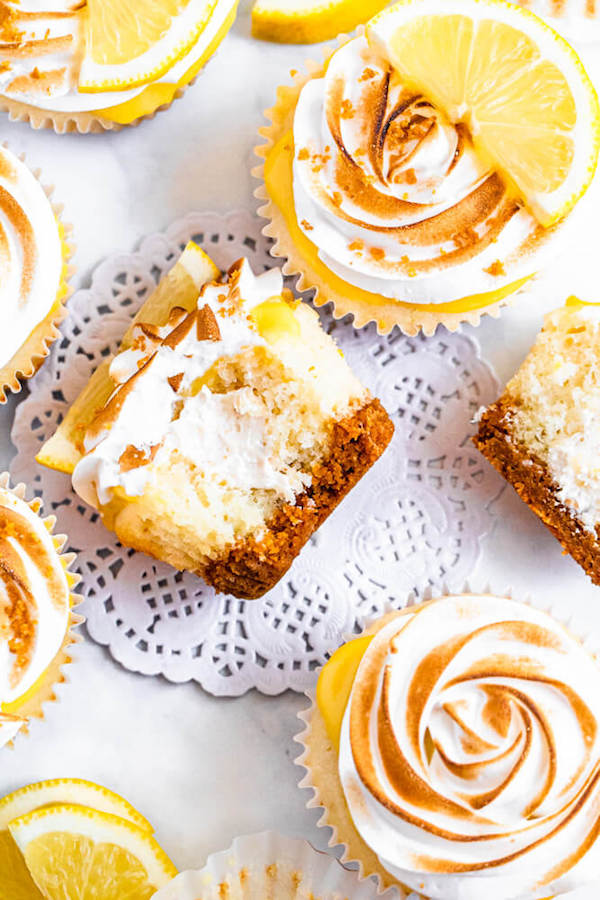 Lemon cupcakes with graham cracker crust, toasted marshmallow filling, lemon curd topping, meringue frosting and a lime and graham cracker crumbs on top