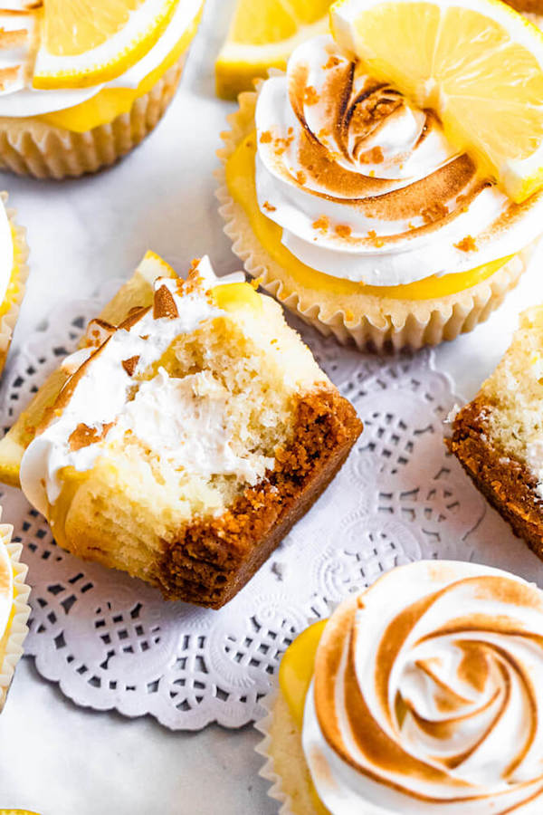 Lemon cupcakes with graham cracker crust, toasted marshmallow filling, lemon curd topping, meringue frosting and a lime and graham cracker crumbs on top