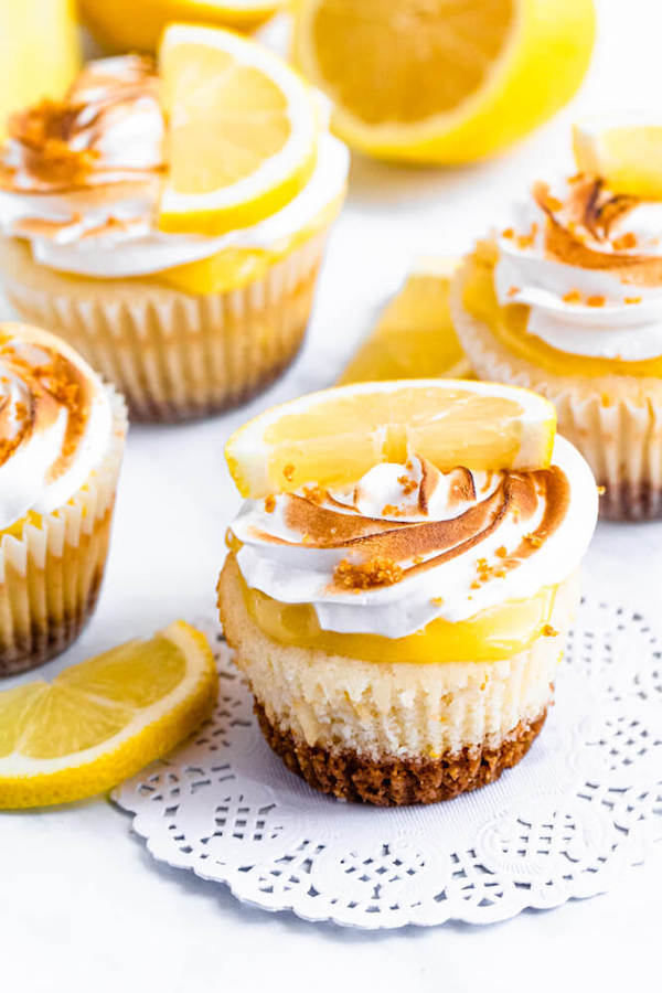 Lemon cupcakes with graham cracker crust, toasted marshmallow filling, lemon curd topping, meringue frosting and a lime and graham cracker crumbs on top