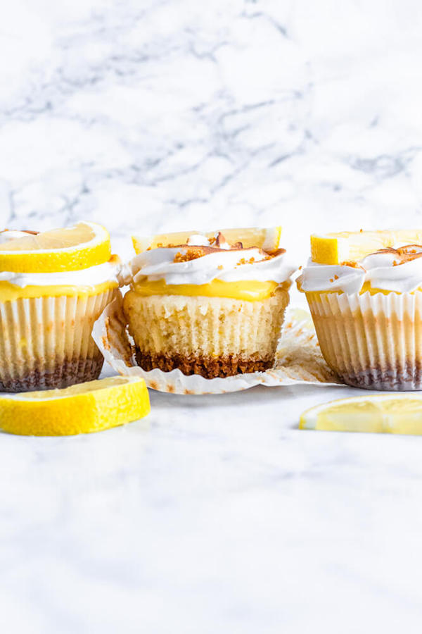 Lemon cupcakes with graham cracker crust, toasted marshmallow filling, lemon curd topping, meringue frosting and a lime and graham cracker crumbs on top