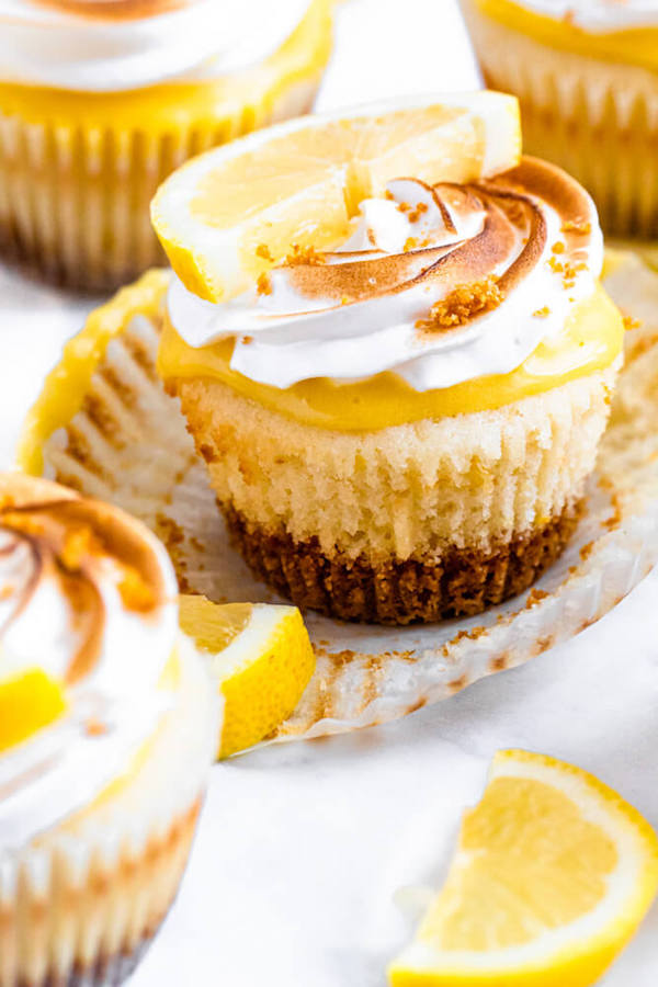 Lemon cupcakes with graham cracker crust, toasted marshmallow filling, lemon curd topping, meringue frosting and a lime and graham cracker crumbs on top