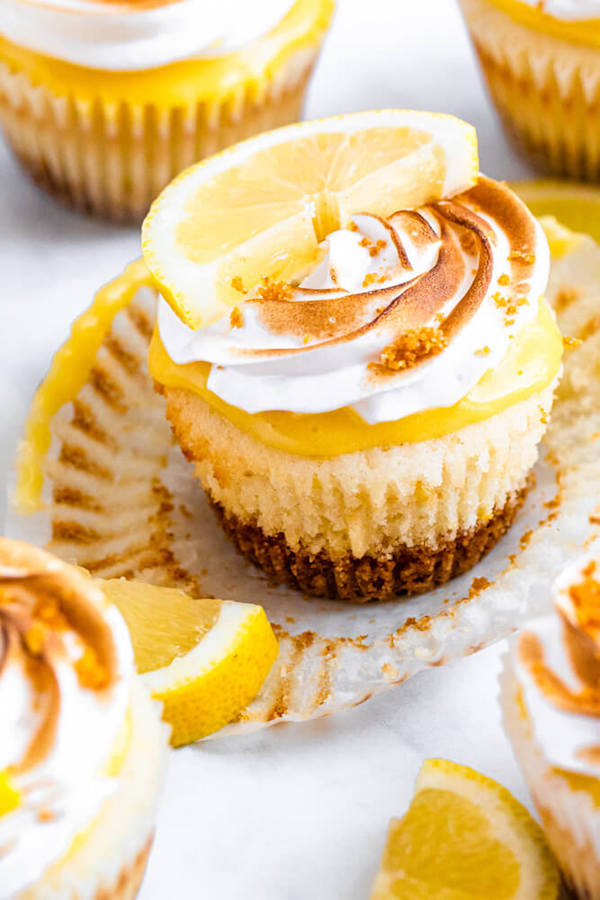 Lemon cupcakes with graham cracker crust, toasted marshmallow filling, lemon curd topping, meringue frosting and a lime and graham cracker crumbs on top