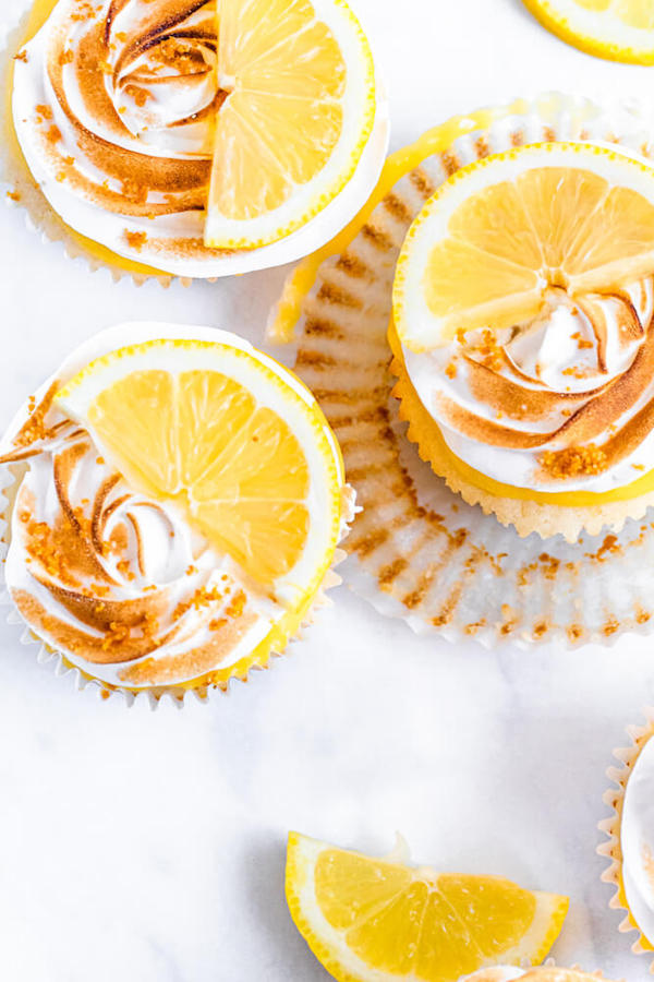 Lemon cupcakes with graham cracker crust, toasted marshmallow filling, lemon curd topping, meringue frosting and a lime and graham cracker crumbs on top