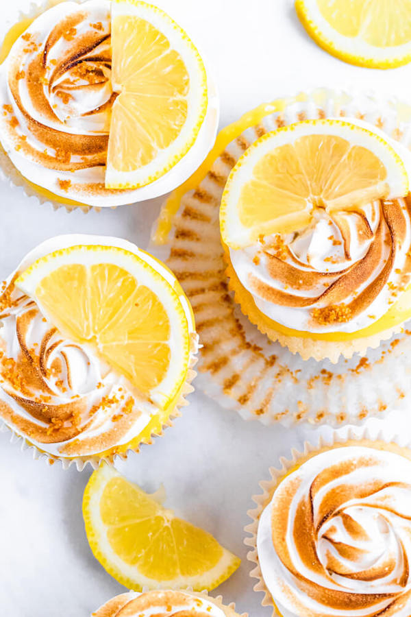 Lemon cupcakes with graham cracker crust, toasted marshmallow filling, lemon curd topping, meringue frosting and a lime and graham cracker crumbs on top