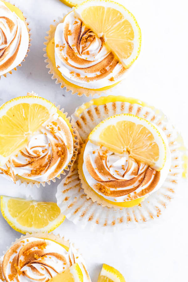 Lemon cupcakes with graham cracker crust, toasted marshmallow filling, lemon curd topping, meringue frosting and a lime and graham cracker crumbs on top