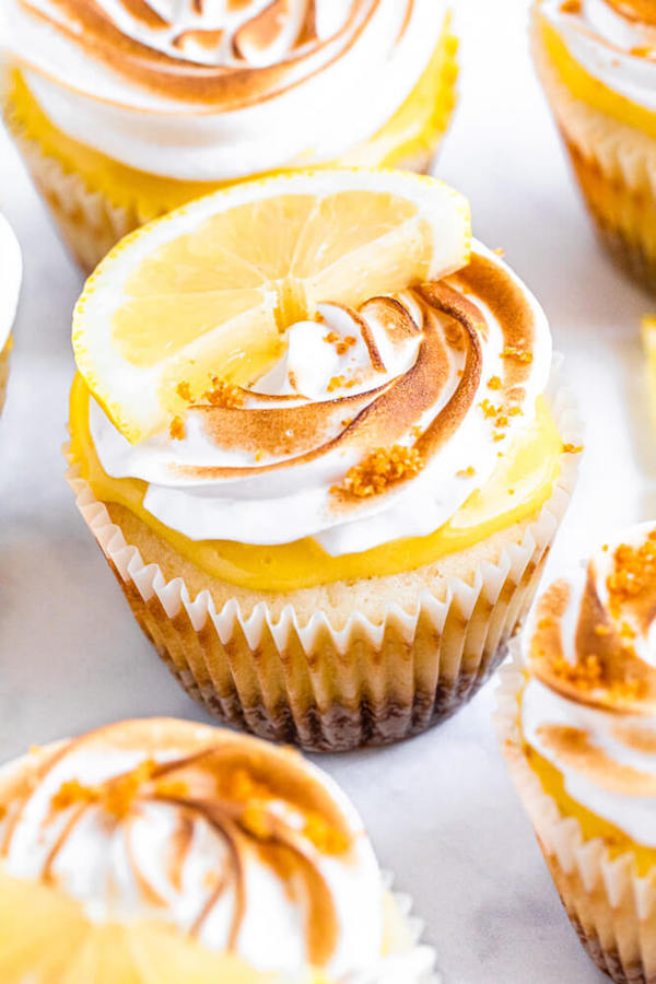 Lemon cupcakes with graham cracker crust, toasted marshmallow filling, lemon curd topping, meringue frosting and a lime and graham cracker crumbs on top