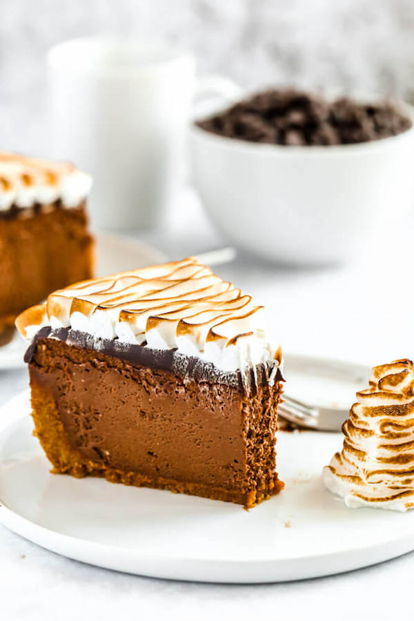 s'mores cheesecake - chocolate cheesecake baked in a graham cracker crust, topped with chocolate ganache and marshmallow meringue