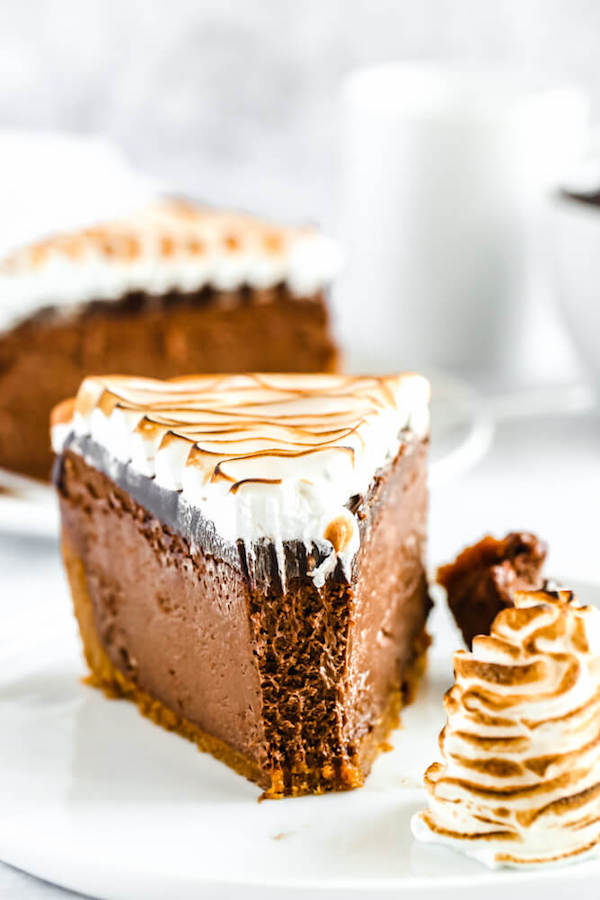 s'mores cheesecake - chocolate cheesecake baked in a graham cracker crust, topped with chocolate ganache and marshmallow meringue