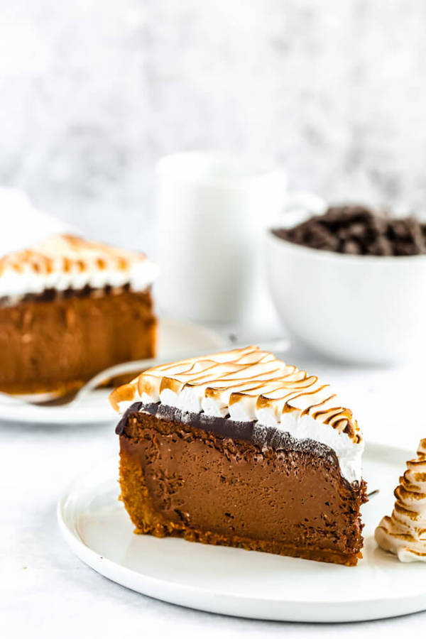 s'mores cheesecake - chocolate cheesecake baked in a graham cracker crust, topped with chocolate ganache and marshmallow meringue