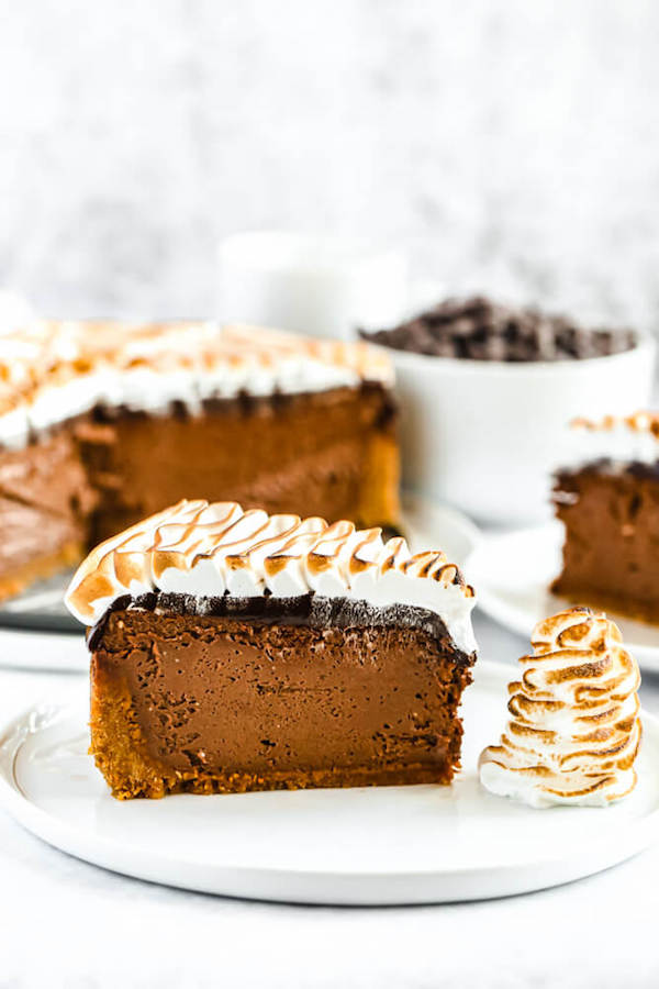 s'mores cheesecake - chocolate cheesecake baked in a graham cracker crust, topped with chocolate ganache and marshmallow meringue