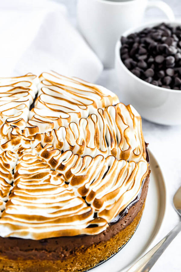 s'mores cheesecake - chocolate cheesecake baked in a graham cracker crust, topped with chocolate ganache and marshmallow meringue