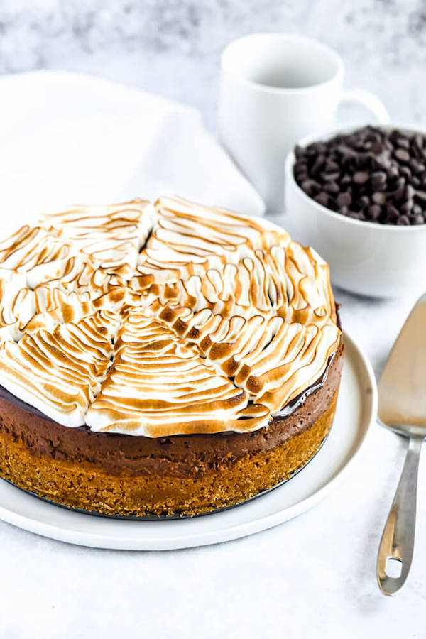 s'mores cheesecake - chocolate cheesecake baked in a graham cracker crust, topped with chocolate ganache and marshmallow meringue