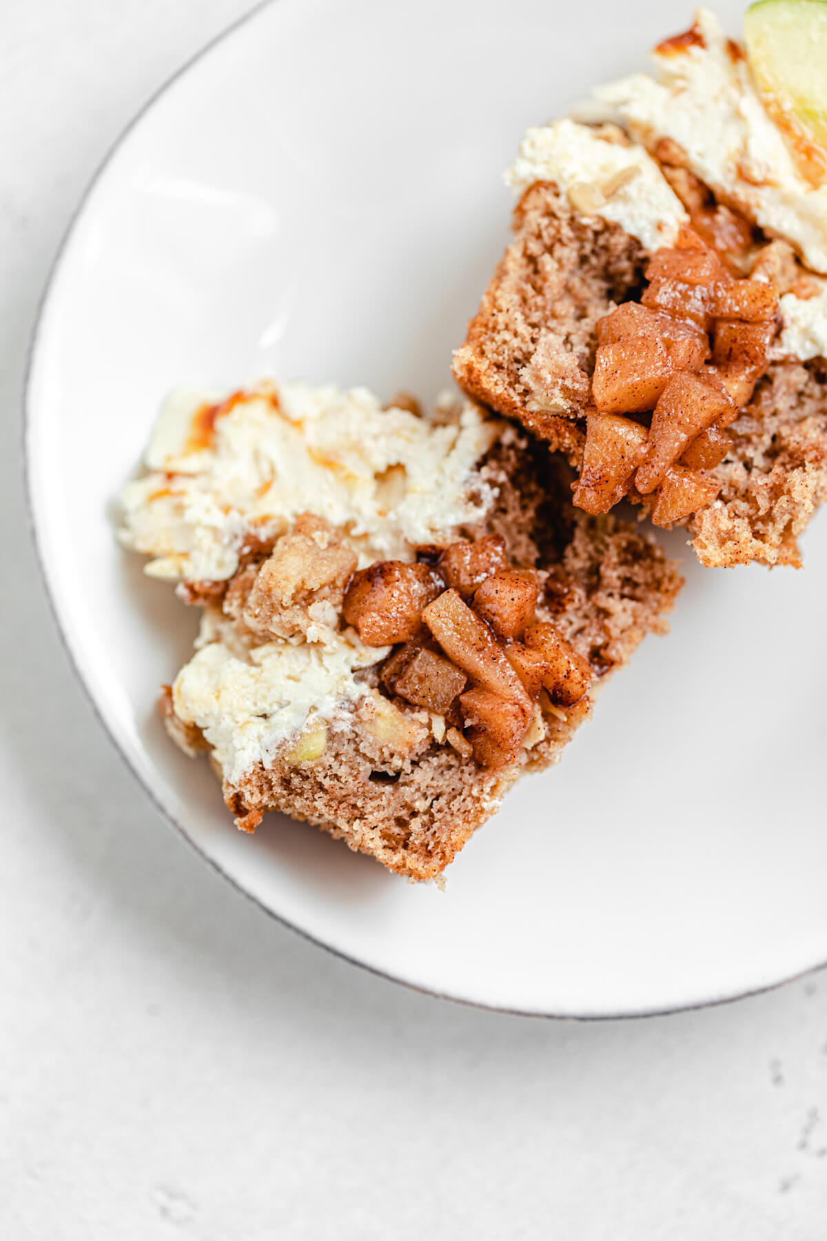 halved cupcakes filled with apple pie filling laying on a small white plate