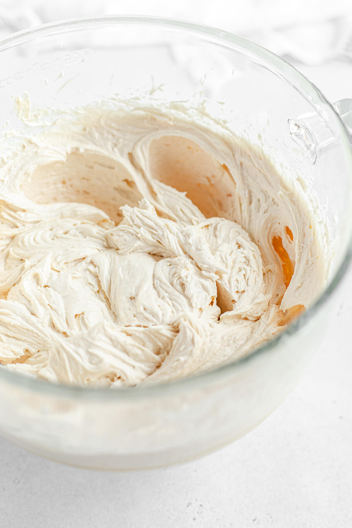 large glass bowl filled with caramel frosting